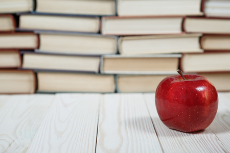 Stack of books and apple on the table. Copy space for text. Selective focus. Knowledge conceptの写真素材