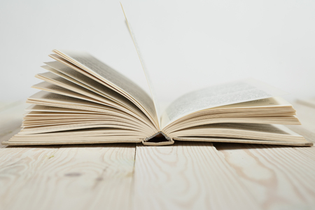 Open of pastel colorsbooks hardback on wooden table. Copy spaceの写真素材