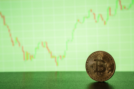 Bitcoin gold coin on the background of the graph of the monitor. Business conceptの写真素材