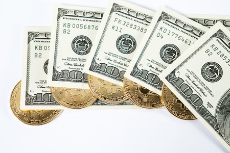 New virtual money Golden bitcoin coin on us dollars background . Cryptocurrency. Business and Trading concept.の写真素材