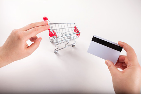 Woman forefinger pushing small shopping cart with Internet online shopping concept.の写真素材
