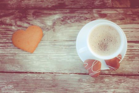 White cup of coffee on a natural old wooden background with biscuits. Selective focus. With copy spaceの写真素材