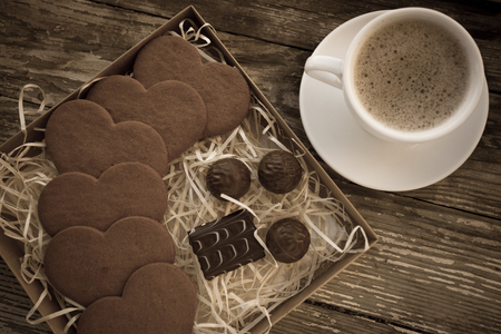 White cup of coffee on a natural old wooden background with biscuits. Selective focus. With copy spaceの写真素材