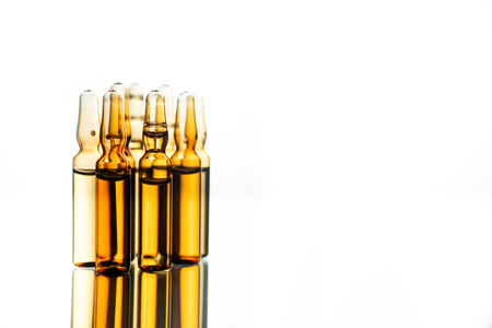 Group object of liquid medicinal agent in limpid glassware in medical laboratory. Group of ampoules with a transparent medicine in medical laboratoryの写真素材