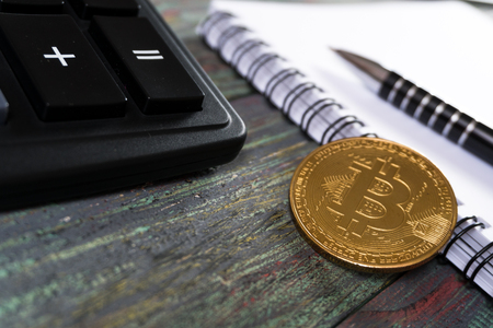 Bitcoin and keyboard calculator in a business office. Bitcoin golden coin New virtual moneyの写真素材