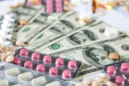 Medical marketing and healthcare business analysis report with graph and many. Pile of pills in blister packs backgroundの写真素材