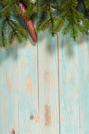 Christmas background  with spruce branches on wooden board with copy spaceの写真素材