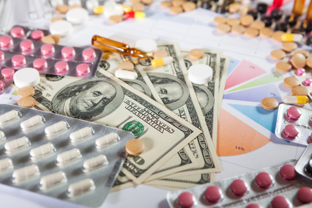Medical marketing and healthcare business analysis report with graph and many. Pile of pills in blister packs backgroundの写真素材