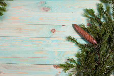 Christmas background with spruce branches on wooden board with copy spaceの写真素材