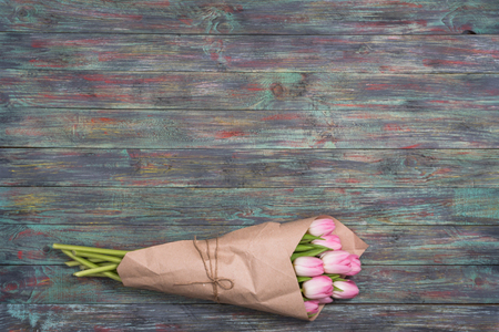 Pink tulips flowers on wooden background. selective focus place for textの写真素材
