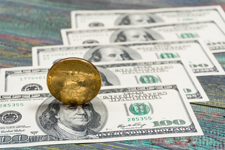 Bitcoin and money on a colored wooden background. Bitcoin golden coin New virtual moneyの写真素材