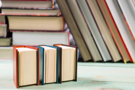 Pile of various books on wooden background. With copy space for your textの写真素材