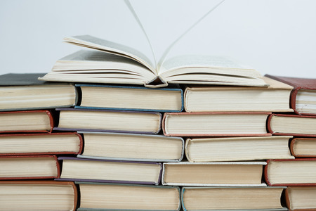 Chaotic stack of old books pastel colors, selective focus with copy spaceの写真素材