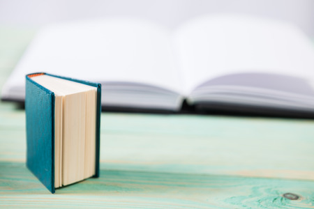 Pile of miniature books on wooden background. With copy space for your textの写真素材