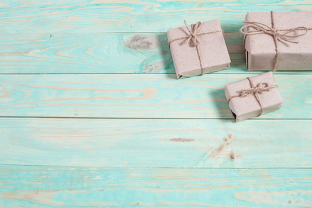 Presents for any holiday concept. Border of decorative gifts wrapped kraft paper tied with tourniquet for christmas, valentine day or birthdayの写真素材