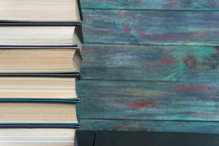 Stack books on wooden background. Back to school with copy space.の写真素材