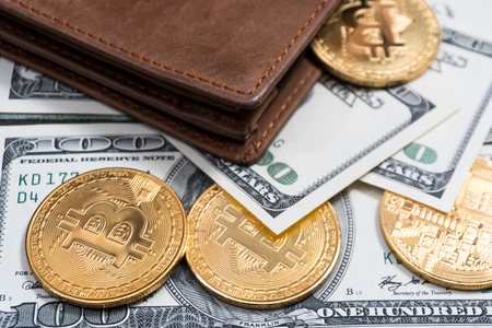 Bitcoin and money in a purse on a colored wooden background. Bitcoin golden coin New virtual moneyの写真素材