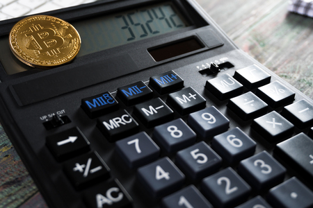 Bitcoin and keyboard calculator in a business office. Bitcoin golden coin New virtual moneyの写真素材