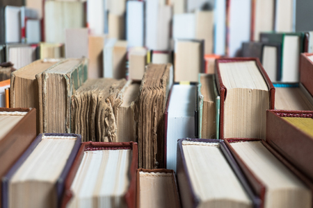 Many books in a bookstore or library on wooden background with copy spaceの写真素材