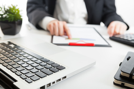 Close up view of bookkeeper or financial inspector hands making report, calculating or checking balance. Marketing strategy brainstorming. Paperwork and digital in office.の写真素材