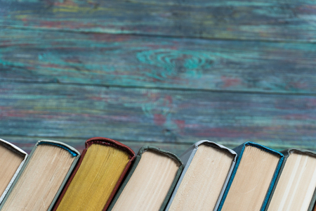 Stack books on wooden background. Back to school with copy space.の写真素材