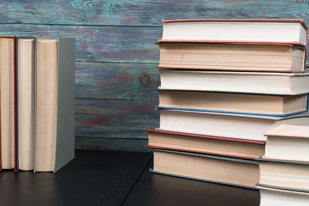 Stack books on wooden background. Back to school with copy space.の写真素材
