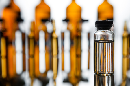 Group object of liquid medicinal agent in limpid glassware in medical laboratory. Group of ampoules with a transparent medicine in medical laboratoryの写真素材