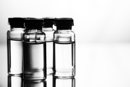 Group object of liquid medicinal agent in limpid glassware in medical laboratory. Group of ampoules with a transparent medicine in medical laboratoryの写真素材