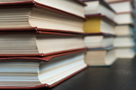 Stack books on wooden background. Back to school with copy space.の写真素材