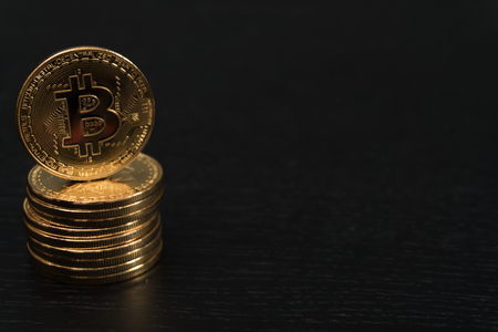gold bitcoin coin new virtual money on a colored wooden backgroundの写真素材