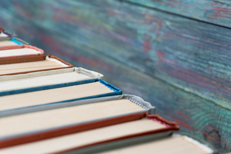 Stack books on wooden background. Back to school with copy space.の写真素材