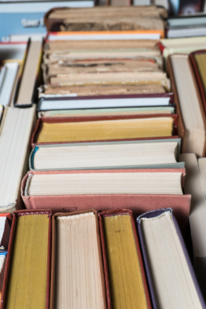 Many books in a bookstore or library on wooden background with copy spaceの写真素材