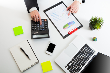 Close up view of bookkeeper or financial inspector hands making report, calculating or checking balance. Marketing strategy brainstorming. Paperwork and digital in office.の写真素材