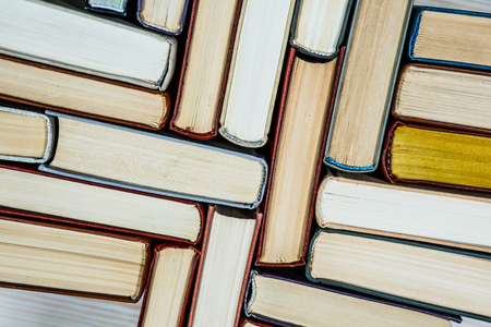 Chaotic stack of old books pastel colors, selective focus with copy spaceの写真素材