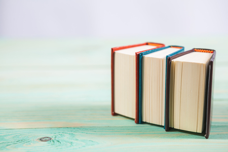 Pile of miniature books on wooden background. With copy space for your textの写真素材