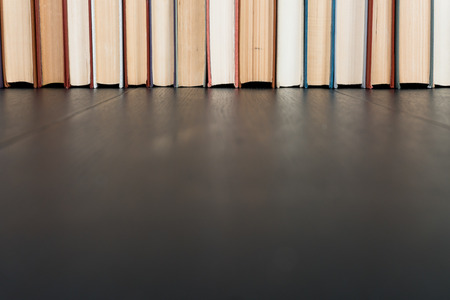Stack books on wooden background. Back to school with copy space.の写真素材