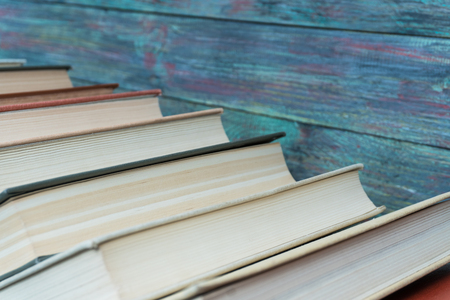 Stack books on wooden background. Back to school with copy space.の写真素材