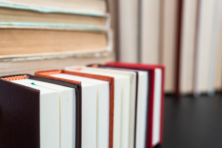 Stack books on wooden background. Back to school with copy space.の写真素材