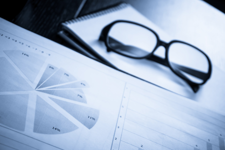 Business accessories on a background of diagrams. Copy space for textの写真素材