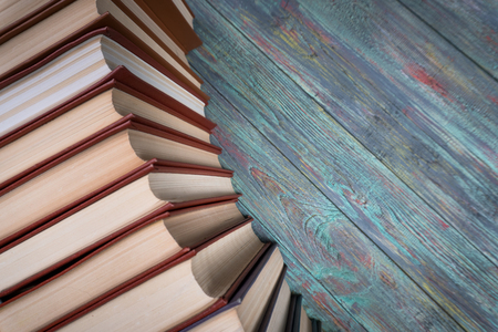 A lot of books on a colored wooden background with copy space.の写真素材