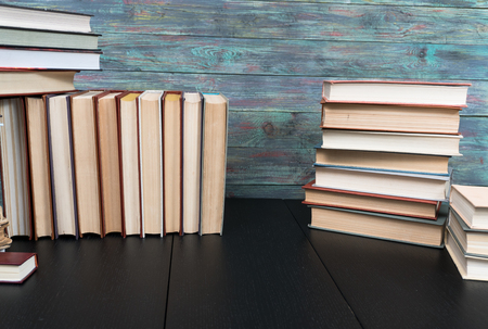 Stack books on wooden background. Back to school with copy space.の写真素材