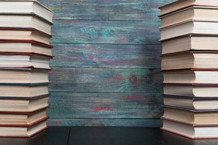 Stack books on wooden background. Back to school with copy space.の写真素材