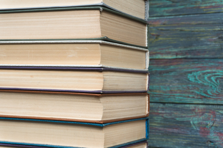 Stack books on wooden background. Back to school with copy space.の写真素材
