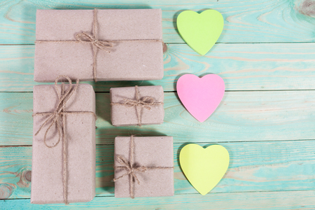 Gift boxes wrapped kraft paper tied with twine and sticker heart and tied with twine. with copy spaceの写真素材
