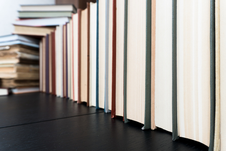 Stack books on wooden background. Back to school with copy space.の写真素材
