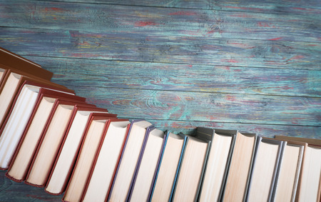 A lot of books on a colored wooden background with copy space.の写真素材