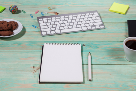 Blue office desk table with with office supplies. Top view with copy spaceの写真素材