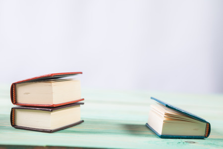 Pile of miniature books on wooden background. With copy space for your textの写真素材