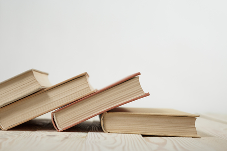 Chaotic stack of old books pastel colors, selective focus with copy spaceの写真素材