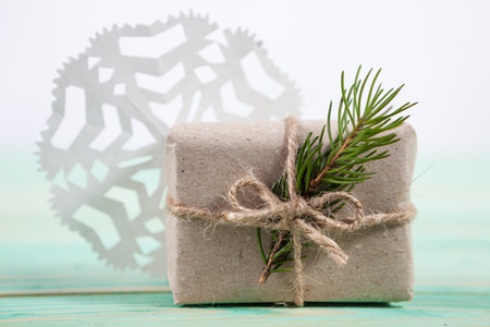 Gift box wrapped kraft paper tied with twine and paper snowflake and tied with twine. with copy spaceの写真素材